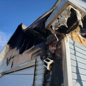 The exterior of a home exhibiting fire damage.