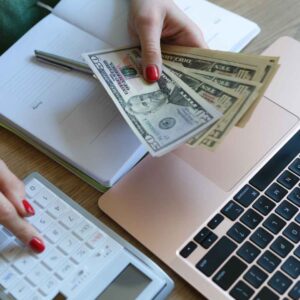 A woman calculating her insurance deductible. Financing